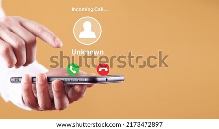 Man showing mobile phone with incoming call from unknown caller. 