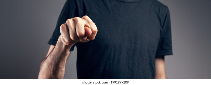 Man Showing Offensive Gesture On Gray Background