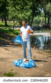 Man Showing Ok Sign Holding Trash Bag