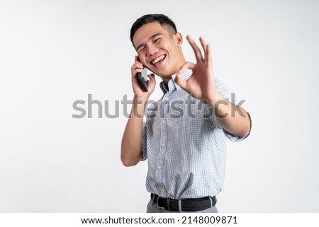 man showing okay gesture while making phone call