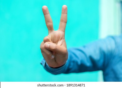 A Man Showing Two Fingers For Victory Symbol. 