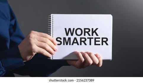 Man showing Work Smarter text on notepad.