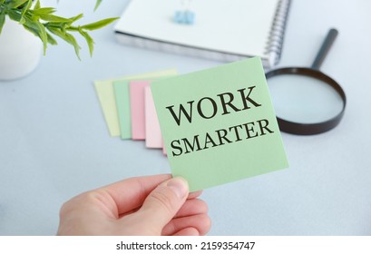 Man showing Work Smarter text on notepad. Business concept