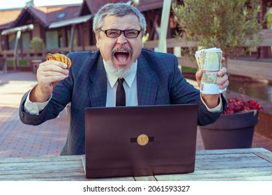 Man Shows Coins Bitcoins And Money Paper Cash, Next To A Laptop For Working On The Exchange. He Enjoys Winning Big Money And A Good Deal.