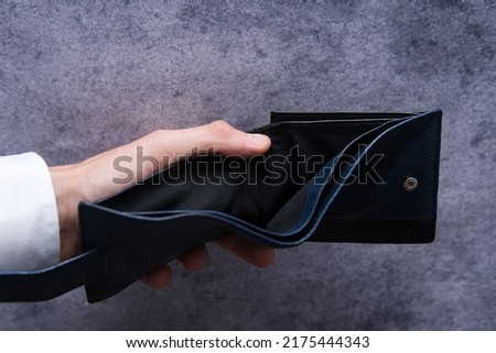 man shows empty wallet. Concept showing bankruptcy, indebtedness and financial difficulties in a time of recession and rising inflation. Increase in mortgage installments