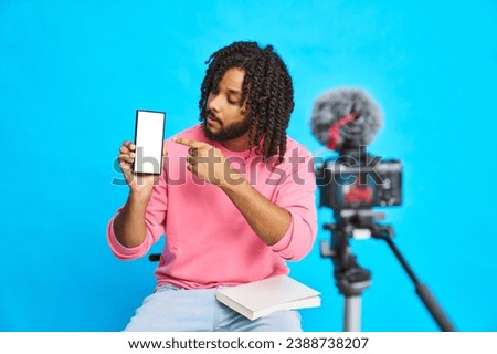 A man shows the mobile screen while streaming is recorded