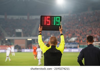 Man shows players substitution during soccer match.