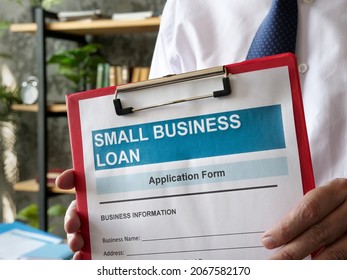 Man Shows Small Business Loan Application With Folder.