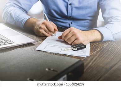 Man Signing Car Insurance Document Or Lease Paper