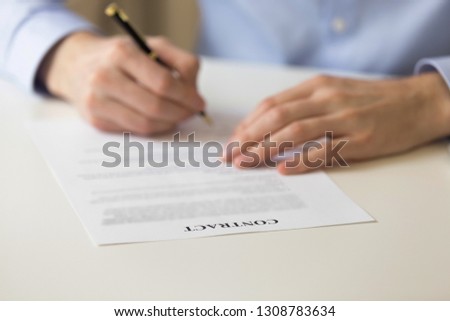 Man signing lawful agreement putting signature on official legal document making purchase or getting insurance close up focused on contract word. Buying selling, human resources or employment concept Stockfoto © 