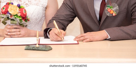 A Man Signs A Marriage Contract