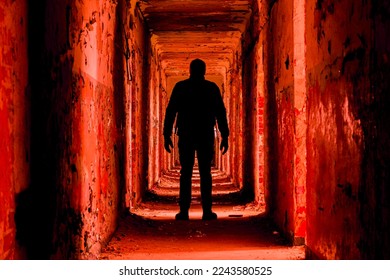 A man silhouette in an abandoned building walkway, red toned version - Powered by Shutterstock