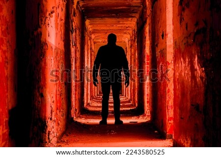 A man silhouette in an abandoned building walkway, red toned version