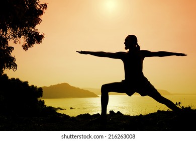 Man Silhouette Doing Virabhadrasana Warrior II Pose Near The Ocean In Gokarna, Karnataka, India