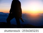 Man Silhouette Photographer take photo on hill high mountain