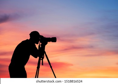 Man Silhouette Photographer take photo on hill high mountain professional camera shooting photo landscape sunset on top mountain nature twilight sky background.