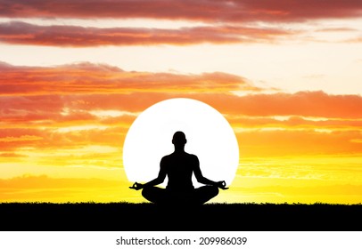 Man Silhouette In Yoga Meditation Pose At Big Sun Background