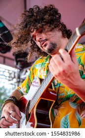 Man Singing And Playing Acustic Guitar At A Concert