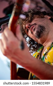 Man Singing And Playing Acustic Guitar At A Concert