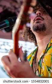 Man Singing And Playing Acustic Guitar At A Concert