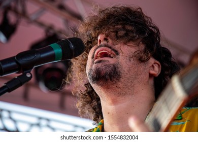 Man Singing And Playing Acustic Guitar At A Concert