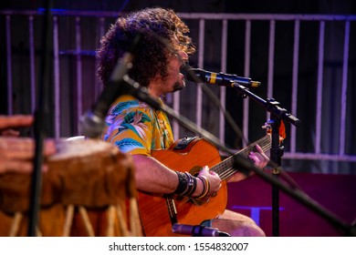 Man Singing And Playing Acustic Guitar At A Concert