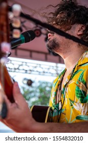 Man Singing And Playing Acustic Guitar At A Concert