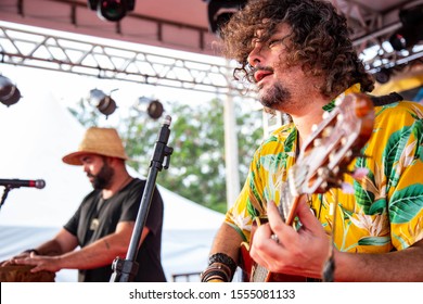 Man Singing And Playing Acustic Guitar At A Concert