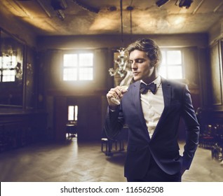 Man Sipping Champagne In An Elegant Setting