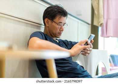 Man Sit Down And Using Mobile And Social Media. Man Playing On Him Smart Phone