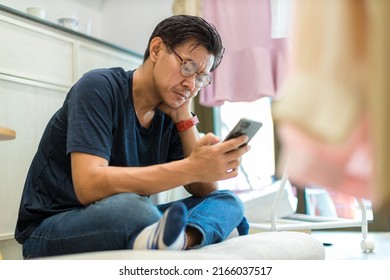 Man Sit Down And Using Mobile And Social Media. Man Playing On Him Smart Phone
