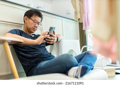 Man Sit Down And Using Mobile. Man Playing On Him Smart Phone	
