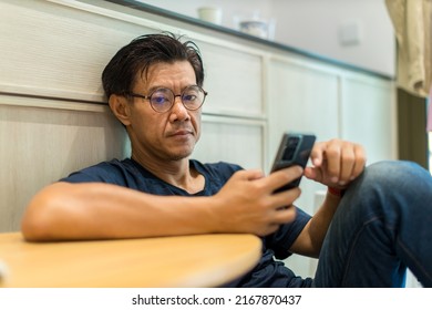 Man Sit Down And Using Mobile And Social Media. Man Playing On Him Smart Phone	