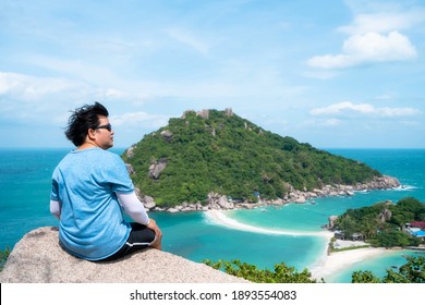 Man Sit On The Rock And Look At View At Nangyuan Island View Point, Place For Tourist Destination At Suratthani, Thailand