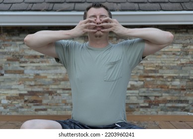 Man Siting In Half-lotus Practicing Bhramari, Humming Bee Breathing, Pranayama