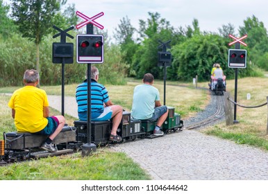 Man Siting On Old Mini Train. Train Model. 