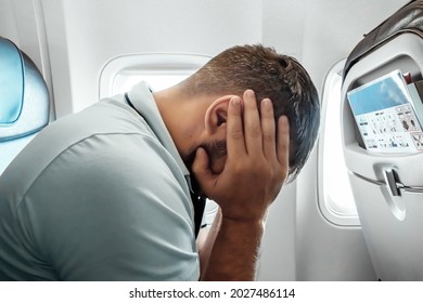 A Man Sits In Front Of An Airplane Window And Is Nervous, Afraid To Fly, The Cabin Of A Passenger Aircraft. Aerophobia, Fobilya, International Flights