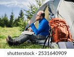 Man sits in tourist tent