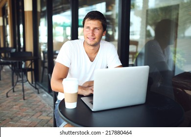 man sitting at cafe and drinking coffee