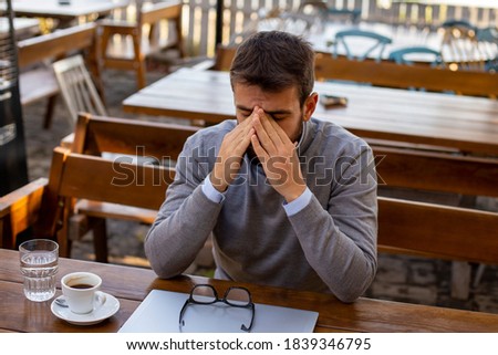 The man sitting in a cafe and thinking