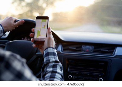 Man Sitting In The Car And Holding Black Mobile Phone With Map Gps Navigation