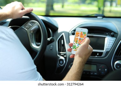 Man Sitting In The Car And Holding Smart Phone With Map Gps Navigation Application