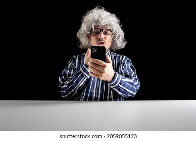 Man Sitting At The Desk Blowing Kiss Having A Videochat Using A Smartphone On Black Background