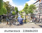 A man sitting down in one bridge of Utrecht, Netherlands