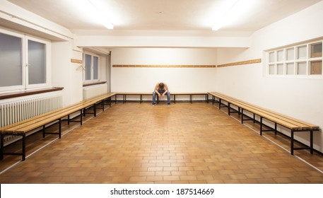 Man Sitting In Empty Locker Room 