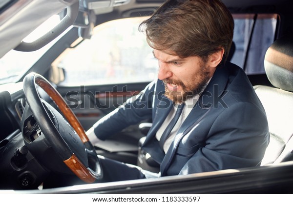 A man is sitting in the front seat in the car           \
         