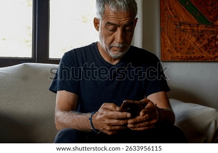 Man sitting at home using smartphome