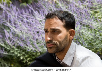 Man sitting in lavender field with expression of failure - Shutterstock ID 1996568447