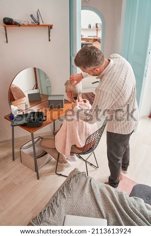 Similar – Carer wearing slippers to elderly female patient