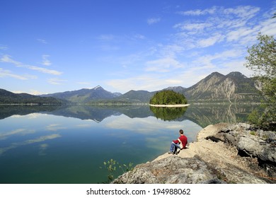 Man Is Sitting Near The Lake